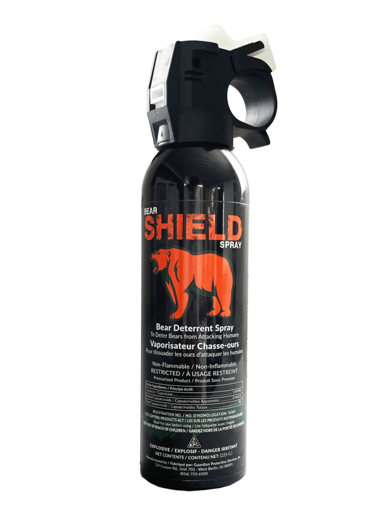 Bear Shield spray bottle designed for deterring bear attacks, featuring a safety cap and clear labeling for effective use.